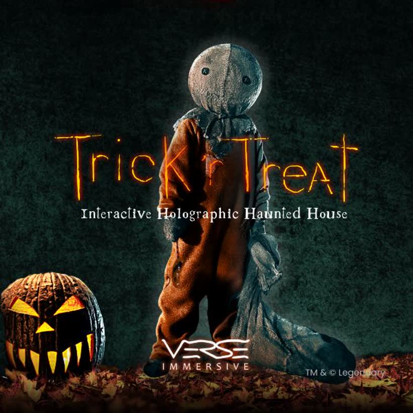 Sam from Trick 'r Treat standing beside a carved pumpkin
